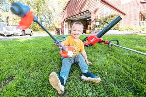 helping dad in the yard. Toy kids weed eater and real one