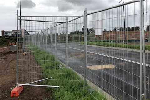 What is the purpose of temporary fencing around construction sites?